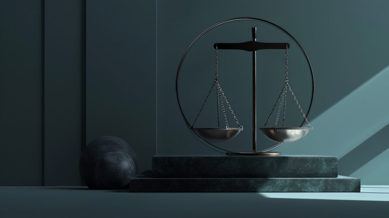 Metal balance scales on marble, symbolising legal precision and fairness, with soft lighting in a professional setting.