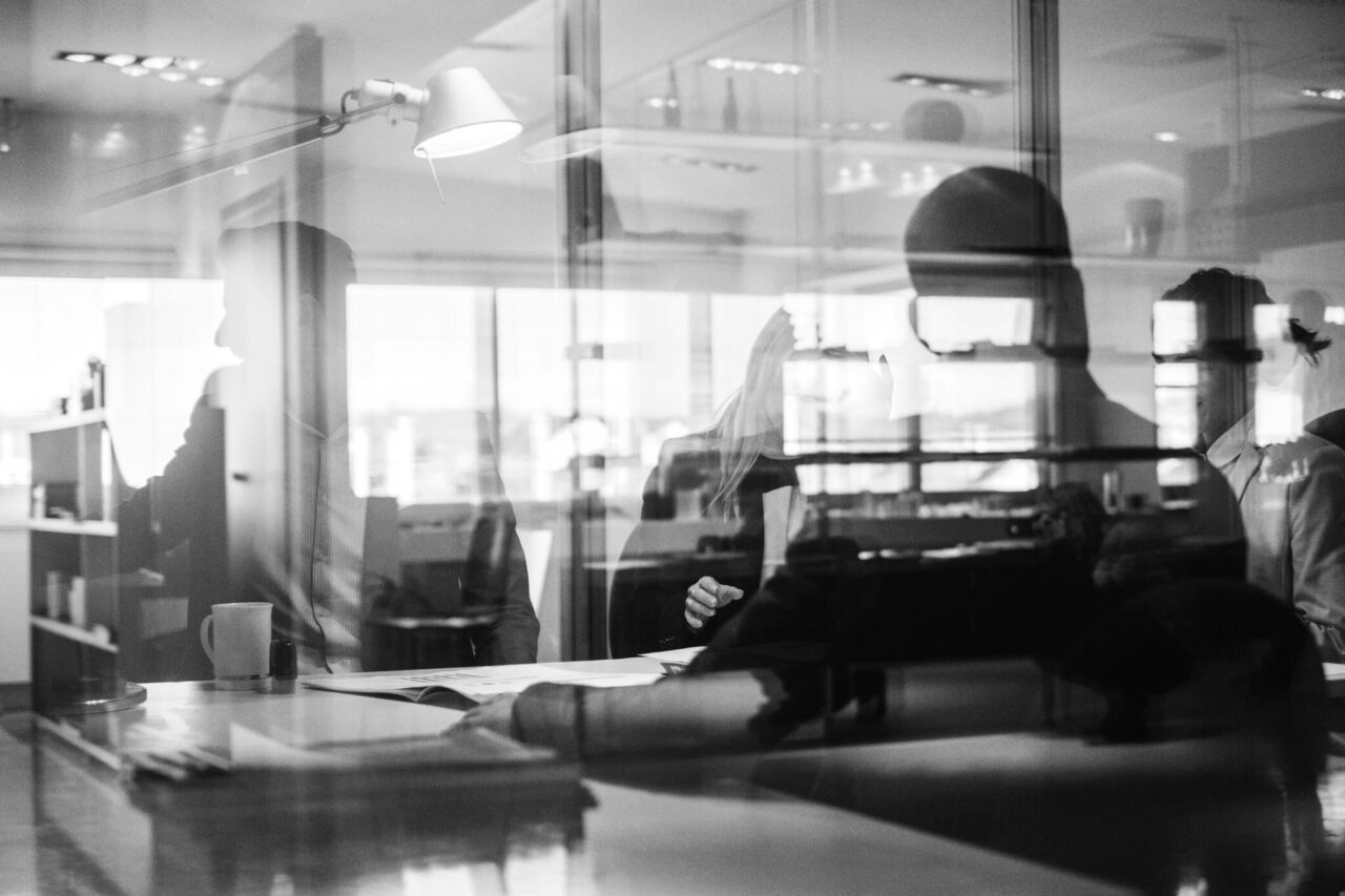 Lawyers meeting in a modern office, discussing personal injury and employment cases through collaborative consultation.